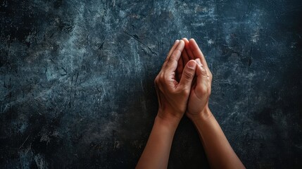 Hands praying on a dark background. Hand praying gesture.