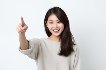 Japanese woman pointing in front of white background