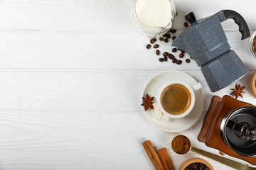 Ingredients for making coffee. Moka pot, Turkish coffee pots (cezve), coffee grinder with coffee beans, milk, sugar and spices on a white background. Drink preparation concept. Flat Lay.Copy space.