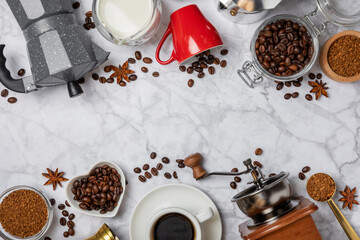 Ingredients for making coffee. Moka pot, turkish coffee pots (cezve), coffee grinder with coffee beans, milk, sugar and spices on a marble background. Drink preparation concept. Flat Lay.Copy space.