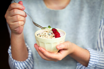 Healthy breakfast greek yogurt, granola and raspberries in the bowl