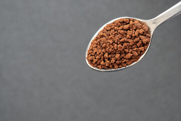 Close up of Instant Coffee on Stainless Steel Tea Spoon, Black Background, Copy Space for Text.