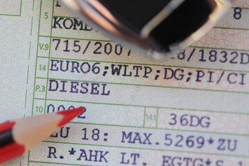 a vehicle registration document with the words (Diesel, Euro 6) and a red pen
