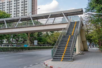 Overhead pedestrian crossing view of the stairs above the highway city road.
