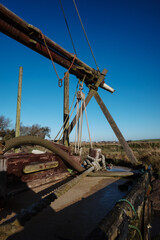 Fototapeta na wymiar deck of old wooden boat with boom on a x stand