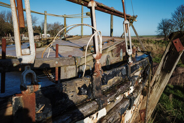 old wooden sail boat slowly rotting away
