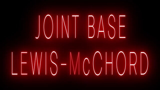 Flickering red retro style neon sign glowing against a black background for JOINT BASE LEWIS-MCCHORD