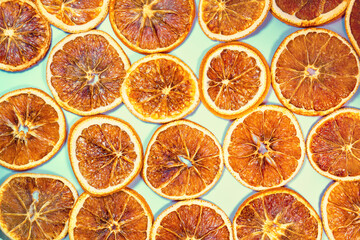 Dry orange slices on a pale blue background