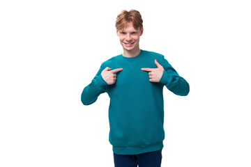 young happy man with red hair dressed in a blue sweater