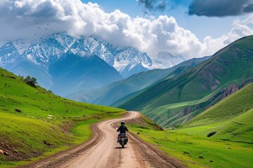 Fototapeta na wymiar Aeriel view of a man riding a motorcycle bike on a mountainous valley road