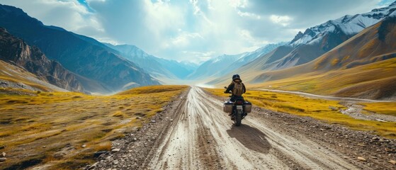 Aeriel view of a man riding a motorcycle bike on a mountainous valley road - Powered by Adobe