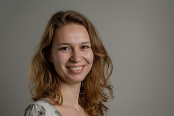 Fototapeta premium A woman with long brown hair is smiling for the camera