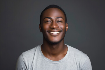 Fototapeta premium A man in a grey shirt is smiling with his eyes closed