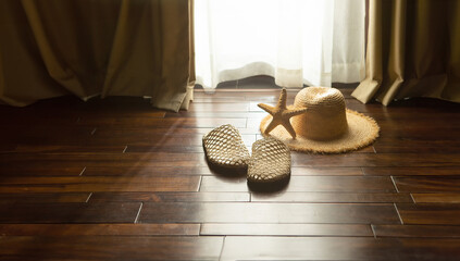 Hat and starfish in a sunny resort room,