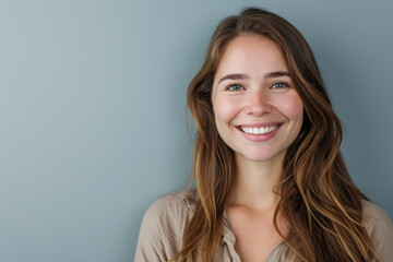 Fototapeta premium A woman with long brown hair is smiling for the camera