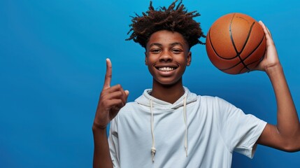 Teenage basketball player against blue wall.