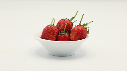 Strawberries in a cup on a white screen