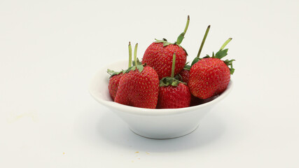 Strawberries in a cup on a white screen