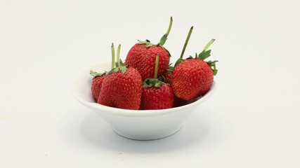 Strawberries in a cup on a white screen