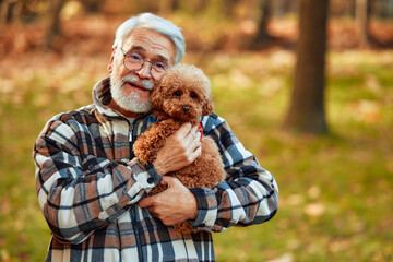 Senior couple walking in the park in autumn