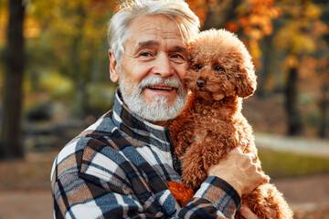 Senior couple walking in the park in autumn