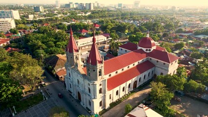 Iloilo City, Philippines - Morning aerial of Molo Church, also known as Saint Anne Parish Church. With the new business district in the background.