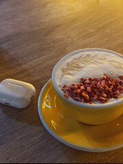 Yellow cup of cheese raf and earbuds