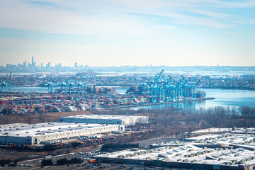 Obraz na płótnie Canvas Aerial view of Shipping Containers, Newark Bay, Panamax cranes, and the Port of Newark - Elizabeth Marine Terminal run by the Port Authority of Newark and New Jersey