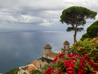 Red flowers at Villa Rufolo gardens with the Amalfi sea in background