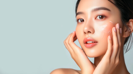 Obraz na płótnie Canvas Asian woman applying anti age cream o resume touching her perfect skin face, beauty skin care concept