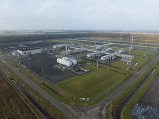 Obraz premium Natural gas fields near Groningen causing earthquakes, Mining of natural resources industrial installation. Birds eye aerial drone view.
