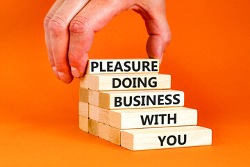 Pleasure doing business with you symbol. Concept words Pleasure doing business with you on wooden blocks. Beautiful orange table orange background. Pleasure doing business with you concept. Copy space