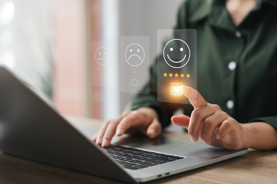 customer satisfaction survey concept businesswoman use laptop Touch the happy smiley icon. Satisfied. 5 stars. Service experience rating. online application Satisfaction Review best quality.