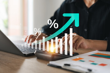 Businesswoman use laptop and calculator analyzing company growth, future business growth arrow graph, development to achieve goals, business outlook, financial data for long term investment.