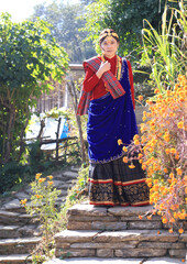 a girl with Gurung traditional dressing a Gurung village in Ghandruk town, Gandaki Province of Nepal, is a point of Annapurna circuit trek and Poonhill trekking in Nepal  - 714798031