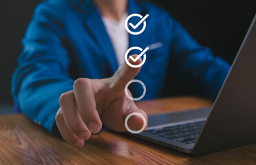 Businessman hand point to tick correct sign mark in checkbox for quality document control checklist...