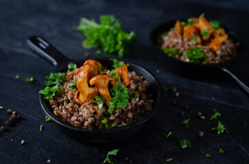 buckwheat groats baked with chanterelles sprinkled with parsley © SUBIEKTYW STOCK