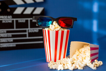 A banner for the film industry. A romantic movie date. A movie camera, 3D glasses, popcorn in...