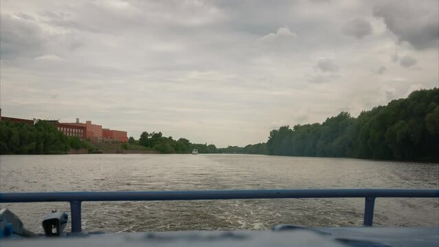 Time lapse. View of the river from the stern of a pleasure boat. Cumulus clouds on a cloudy sky