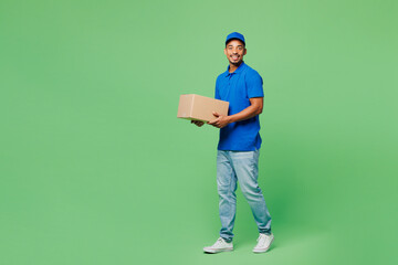 Full body fun delivery guy employee man wears blue cap t-shirt uniform workwear work as dealer...