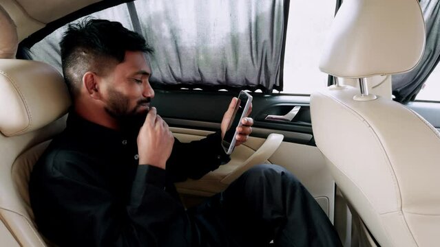 Smiling man using smart phone shocking and laughing talking in luxury car interior - Powered by Adobe