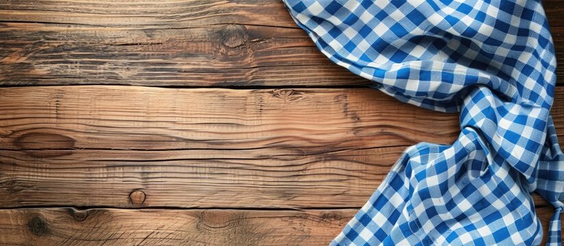 Copy space on a wooden table with a checkered cloth.