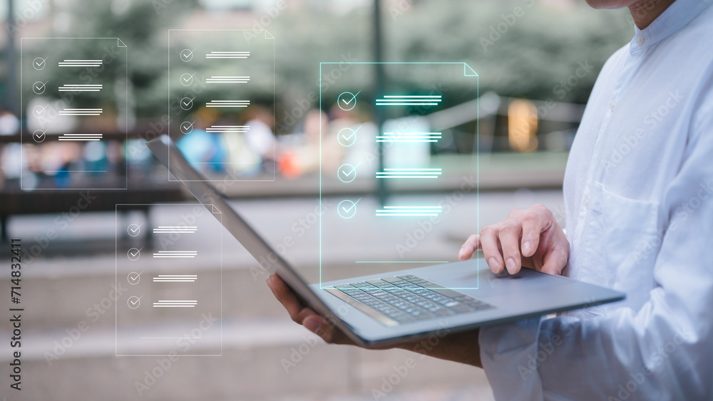Wall mural businessman using computer laptop outdoor with virtual document icon in concept of document and data