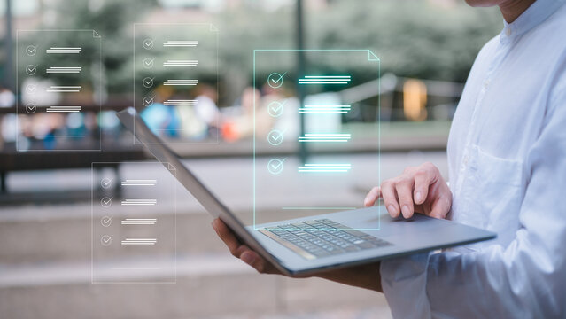 businessman using computer laptop outdoor with virtual document icon in concept of document and data analysis