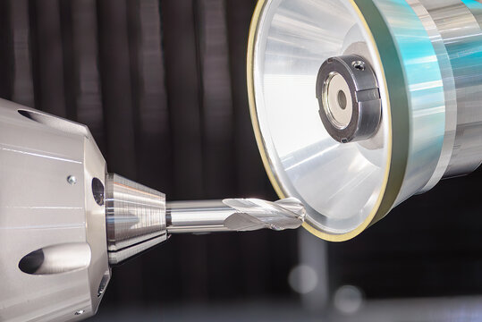 Close up scene the ball nose end mill tool regrinding process on regrinding machine.