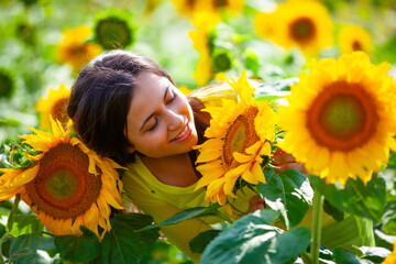 young girl in a field with sunflowers - 714840885