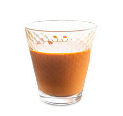Hot orange Thai tea sweetened condensed milk in transparent glass isolated on white background with clipping path