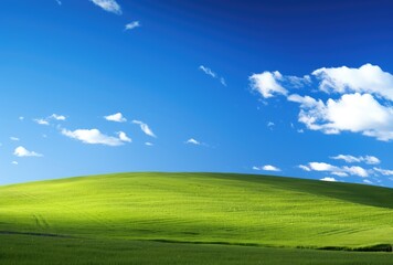 Obraz premium Rolling green hills beneath a brilliant blue sky adorned with fluffy clouds.