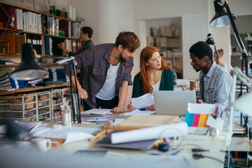 Diverse young people collaborating on a project in a modern workspace