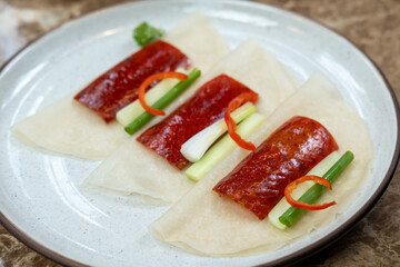Deep fried Peking duck skin, served on plate